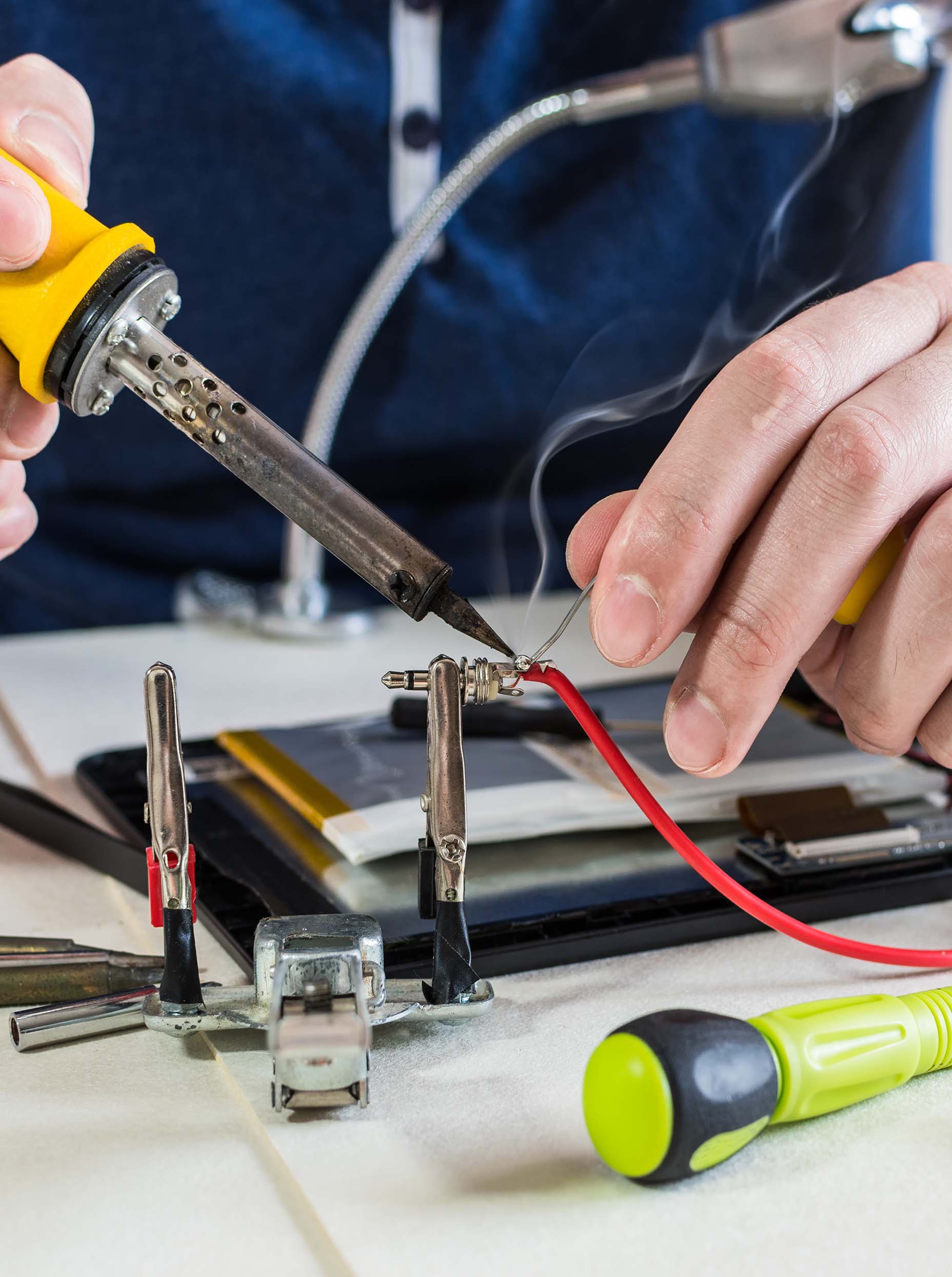 vertical-shot-of-male-hands-soldering-a-cable-to-a-2026-01-08-00-30-00-utc